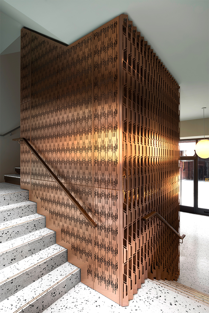 Laser-cut, V-grooved and folded PVD coloured stainless steel forming interior cladding around lift shaft. - The Gaslight Building, 29 – 35 Rathbone Street, London - Developer I.S.A Holdings - Interior architecture and design: bureau de change design office - Architects: dMFK Architects - Laser-cut PVD coloured stainless steel in custom Bronze Hairline for stairs, lift core and architectural detailing by Double Stone Steel in partnership with Double Stone Steel Europe Ltd. - Photography by Gilbert McCarragher