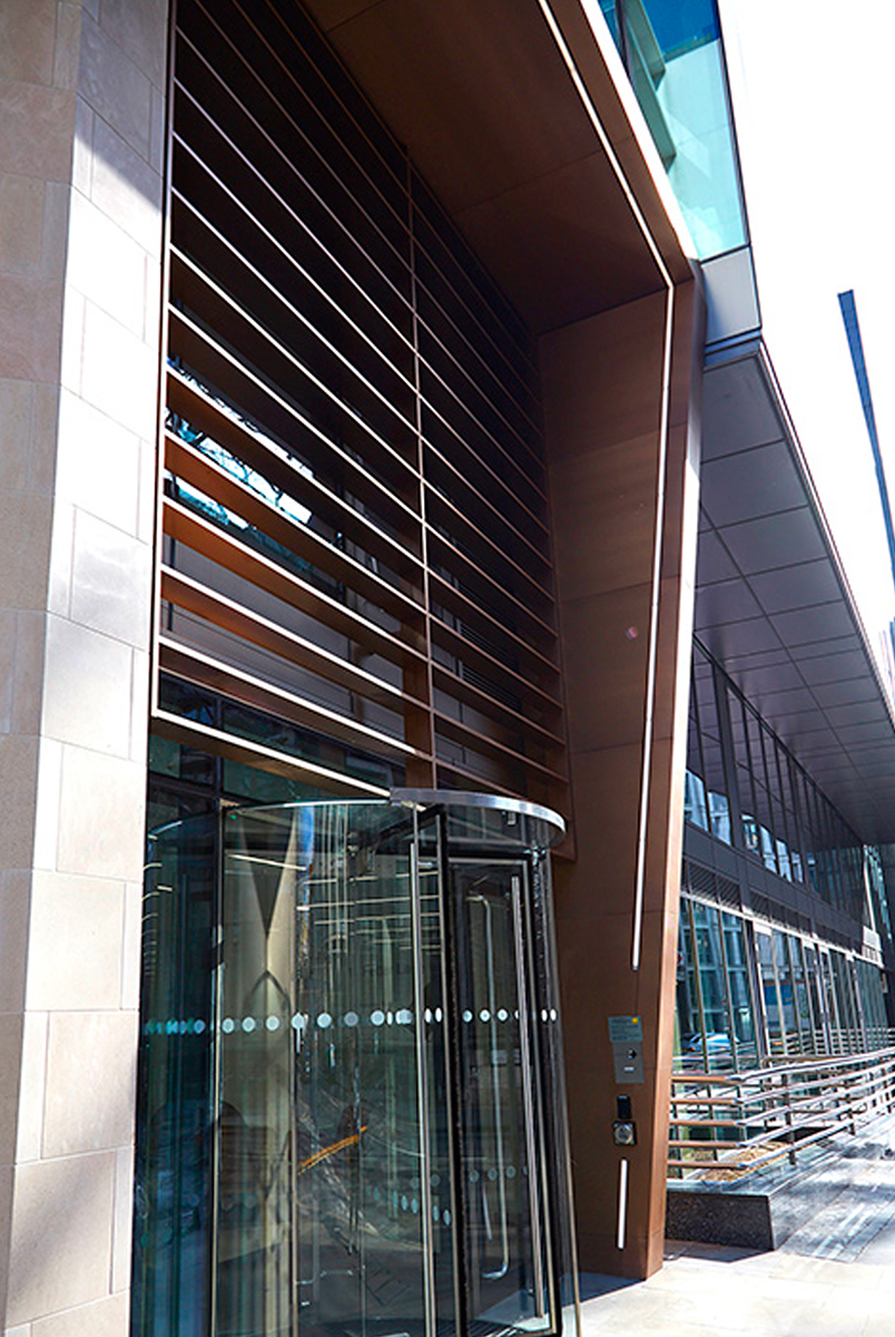 Brise Soleil, tapered column and canopy in Chocolate PVD stainless steel V-Grooved and folded to appear as solid bronze. Office building, 15 Fetter Lane, EC4A, London - Architects: McBains Cooper - Client: British Steel Pension Fund Trustees Ltd - Fit-out: Nucom Interiors - PVD stainless steel & fabrication: Double Stone Steel Europe Ltd.