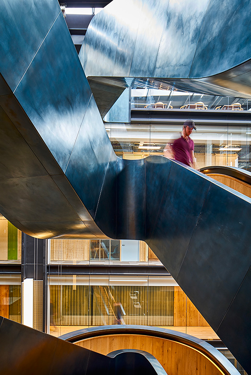 Staircase in blackened stainless steel with over-wax finish for Google headquarters. Google offices, 6 Pancras Square, London, UK - Architects: AHMM - Main contractor: ISG - Staircase fabrication, installation and finishing: Double Stone Steel Europe Ltd - Structural engineers for Double Stone Steel Europe Ltd: AECOM - Photography by Tim Soar