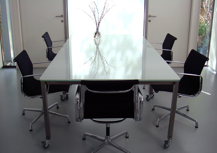 Work table fabricated from shot-peened stainless steel and white glass Work table fabricated from shot-peened stainless steel and white glass