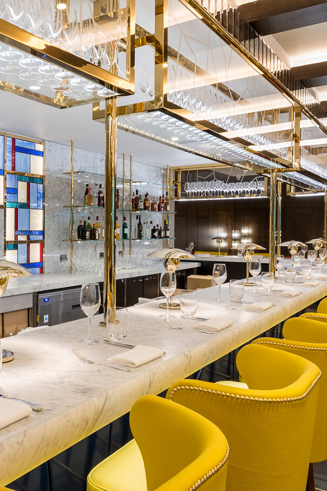 The long bar in the Brasserie in V-Grooved Champagne Mirror PVD. The Devonshire Club Hotel Interior Design: March & White PVD coloured stainless steel: Double Stone Steel Europe Ltd