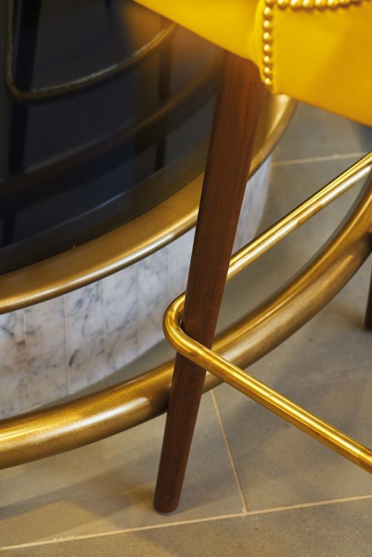Detail of the bar rail in the Brasserie. - The Devonshire Club Hotel - Interior Design: March & White - PVD coloured stainless steel: Double Stone Steel Europe Ltd