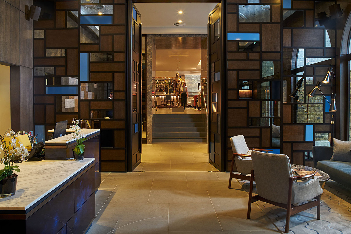 The Reception area looking through to the Champagne Bar. The Devonshire Club Hotel Interior Design: March & White PVD coloured stainless steel: Double Stone Steel Europe Ltd
