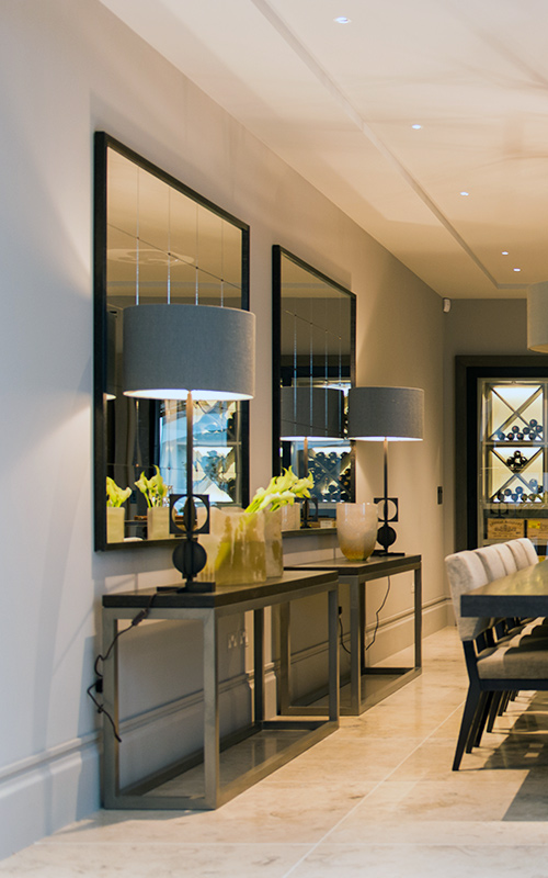 Console table with over-sized mirrors in dining/wine-tasting area. Bedford Gardens, London. Architects: Nash Baker Interior Designers: DeSalles Flint Architectural metalwork & PVD stainless steel: Double Stone Steel Europe Ltd