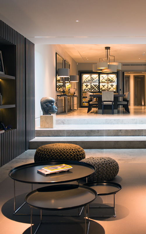 Home cinema looking through to dining/wine-tasting area. Bedford Gardens, London. Architects: Nash Baker Interior Designers: DeSalles Flint Architectural metalwork & PVD stainless steel: Double Stone Steel Europe Ltd