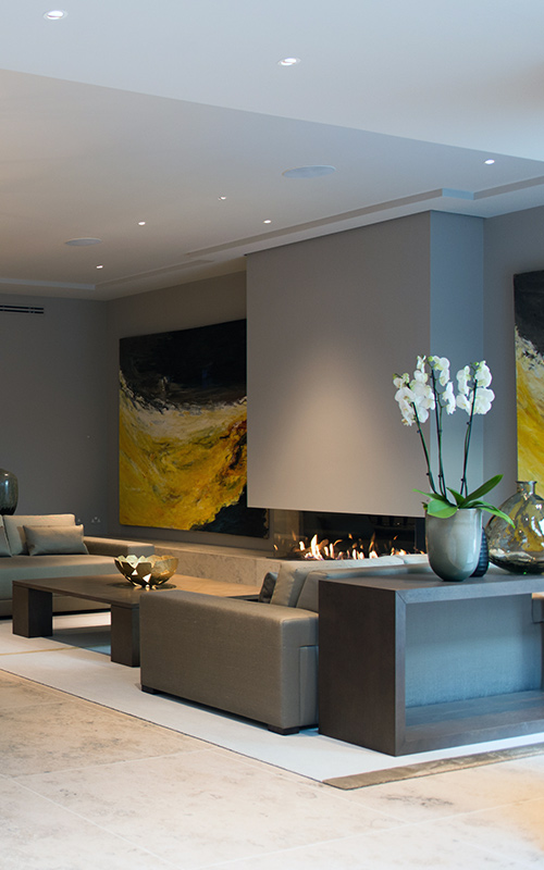 Relaxed sitting area with large format paintings. Bedford Gardens, London. Architects: Nash Baker Interior Designers: DeSalles Flint Architectural metalwork & PVD stainless steel: Double Stone Steel Europe Ltd