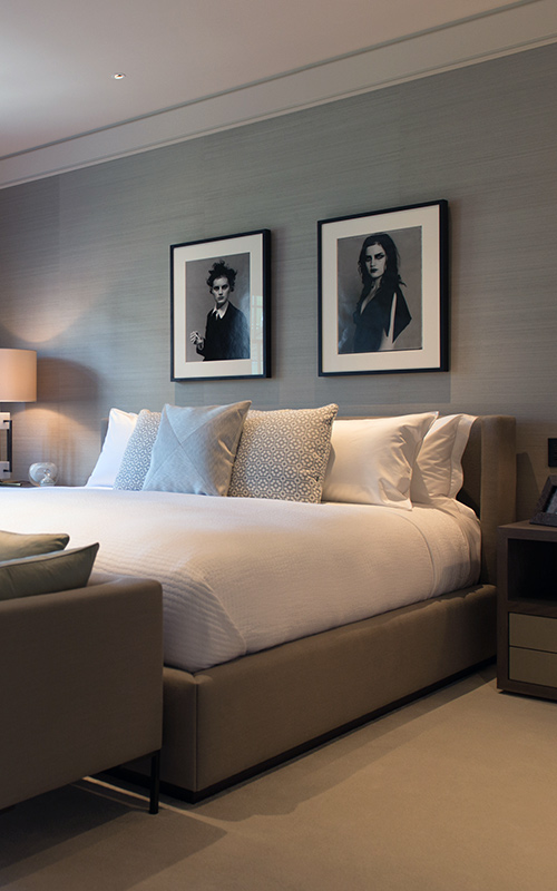 Bedroom with black and white portrait photography. Bedford Gardens, London. Architects: Nash Baker Interior Designers: DeSalles Flint Architectural metalwork & PVD stainless steel: Double Stone Steel Europe Ltd