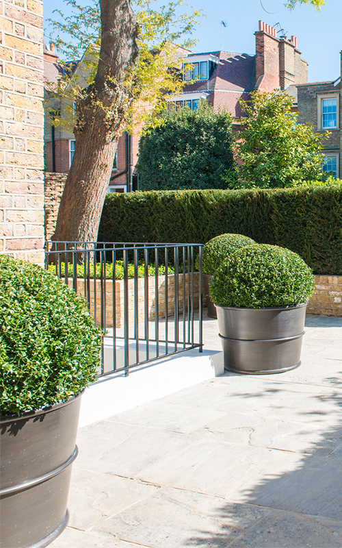 Front garden with patinated brass planters. Bedford Gardens, London. - Architects: Nash Baker - Interior Designers: DeSalles Flint - Architectural metalwork & specialist metal finishes: Double Stone Steel Europe Ltd