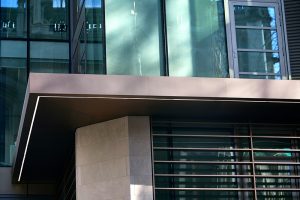 Detail of the canopy. - 15 Fetter Lane, EC4A, London. - Bronze PVD coloured textured stainless steel in Chocolate for Brise soleil, canopy and column. - Architectural metalworks and PVD by John Desmond Ltd.