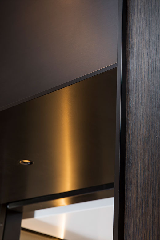 Close up view of elevator architrave and panels in V-Grooved PVD coloured stainless steel in Chocolate Vibration. - Fenman House, Apartment Building, 9 Handyside St, King’s Cross, London N1C. - V-Grooving and folding by Double Stone Steel Europe Ltd Close up view of elevator architrave and panels in V-Grooved PVD coloured stainless steel in Chocolate Vibration. - Fenman House, Apartment Building, 9 Handyside St, King’s Cross, London N1C. - V-Grooving and folding by Double Stone Steel Europe Ltd