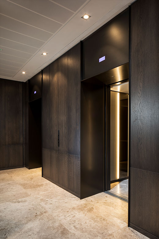 Elevator lobby with architrave and trim complementing the Wenge panelling and travertine floor. - Elevator architrave and panels in PVD coloured stainless steel in Chocolate Vibration. - Fenman House, Apartment Building, 9 Handyside St, King’s Cross, London N1C. - V-Grooving and folding of stainless steel by Double Stone Steel Europe Ltd Elevator lobby with architrave and trim complementing the Wenge panelling and travertine floor. - Elevator architrave and panels in PVD coloured stainless steel in Chocolate Vibration. - Fenman House, Apartment Building, 9 Handyside St, King’s Cross, London N1C. - V-Grooving and folding of stainless steel by Double Stone Steel Europe Ltd