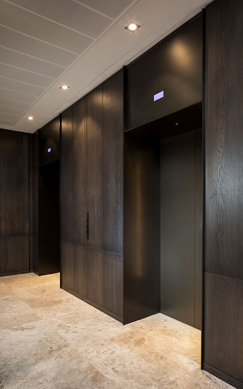 Elevator lobby with architrave and trim complementing the Wenge panelling and travertine floor. - Elevator architrave and panels in V-Grooved PVD coloured stainless steel in Chocolate Vibration. Fenman House, Apartment Building, 9 Handyside St, King’s Cross, London N1C. - Fabrication, V-Grooving and folding of stainless steel by Double Stone Steel Europe Ltd. Elevator lobby with architrave and trim complementing the Wenge panelling and travertine floor. - Elevator architrave and panels in V-Grooved PVD coloured stainless steel in Chocolate Vibration. Fenman House, Apartment Building, 9 Handyside St, King’s Cross, London N1C. - Fabrication, V-Grooving and folding of stainless steel by Double Stone Steel Europe Ltd.