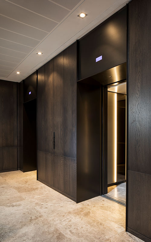 Elevator lobby with architrave and trim complementing the Wenge panelling and travertine floor. - Elevator architrave and panels in V-Grooved PVD coloured stainless steel in Chocolate Vibration. Fenman House, Apartment Building, 9 Handyside St, King’s Cross, London N1C. - Fabrication, V-Grooving and folding of stainless steel by Double Stone Steel Europe Ltd. Elevator lobby with architrave and trim complementing the Wenge panelling and travertine floor. - Elevator architrave and panels in V-Grooved PVD coloured stainless steel in Chocolate Vibration. Fenman House, Apartment Building, 9 Handyside St, King’s Cross, London N1C. - Fabrication, V-Grooving and folding of stainless steel by Double Stone Steel Europe Ltd.