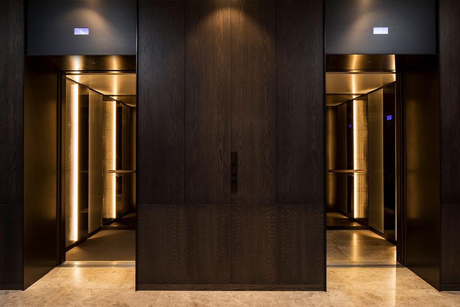 Warm lighting creates a welcoming lift cab interior. - Elevator architrave and panels in V-Grooved PVD coloured stainless steel in Chocolate Vibration. Fenman House, Apartment Building, 9 Handyside St, King’s Cross, London N1C. - Fabrication, V-Grooving and folding of stainless steel by Double Stone Steel Europe Ltd. Warm lighting creates a welcoming lift cab interior. - Elevator architrave and panels in V-Grooved PVD coloured stainless steel in Chocolate Vibration. Fenman House, Apartment Building, 9 Handyside St, King’s Cross, London N1C. - Fabrication, V-Grooving and folding of stainless steel by Double Stone Steel Europe Ltd.