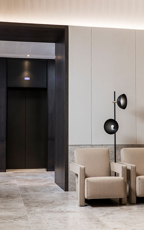 The Bronze tones of the elevator lobby are harmonious with the colours and finishes in the reception area. - Elevator architrave and panels in V-Grooved PVD coloured stainless steel in Chocolate Vibration. Fenman House, Apartment Building, 9 Handyside St, King’s Cross, London N1C. - Fabrication, V-Grooving and folding of stainless steel by Double Stone Steel Europe Ltd. The Bronze tones of the elevator lobby are harmonious with the colours and finishes in the reception area. - Elevator architrave and panels in V-Grooved PVD coloured stainless steel in Chocolate Vibration. Fenman House, Apartment Building, 9 Handyside St, King’s Cross, London N1C. - Fabrication, V-Grooving and folding of stainless steel by Double Stone Steel Europe Ltd.