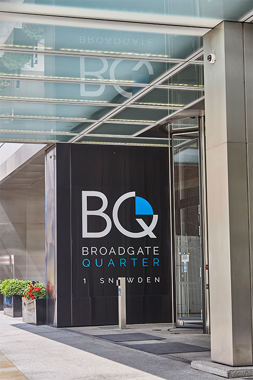 Frameless Glazed Satin Stainless Steel Canopy. 1 Broadgate Quarter, Snowden St, London, EC2A 2AW - Architects: John Robertson Architects. - Stainless Steel Canopy: Double Stone Steel Europe Ltd. - The canopy creates a sense of arrival and of welcome.