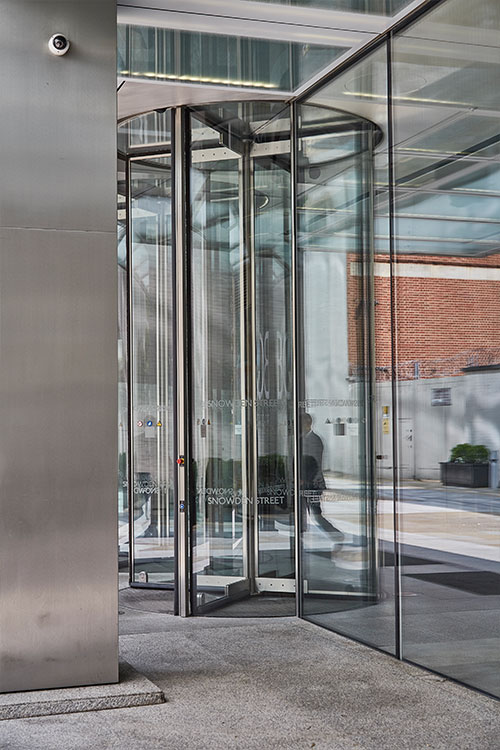 Frameless Glazed Satin Stainless Steel Canopy. 1 Broadgate Quarter, Snowden St, London, EC2A 2AW - Architects: John Robertson Architects. - Stainless Steel Canopy: Double Stone Steel Europe Ltd. - The revolving doors are integrated into the canopy space.