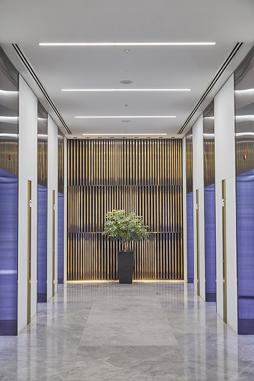 1 Broadgate Quarter, Snowden St, London, EC2A 2AW - Architects: John Robertson Architects. - Stainless Steel Canopy: Double Stone Steel Europe Ltd. - The feature wall of narrow brass bars creates a warm backdrop to the glossy, contemporary finishes.