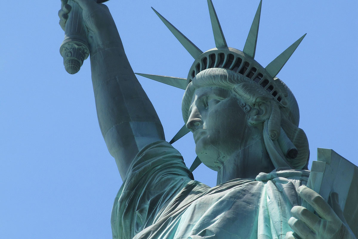 The Statue of Liberty in New York Harbour. The statue is made of copper which, when exposed to air, reacts with oxygen to produce a green layer of copper oxide known as a patina.