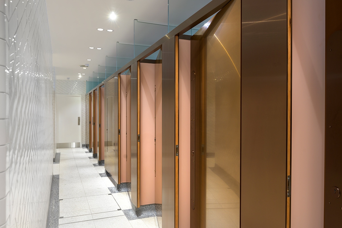 Interior of upgraded WCs Victoria Station, London with 18 mm thick glossy white brick and curved terrazzo skirting for ease of cleaning. Client: Network Rail Architects: Landolt + Brown Fitout: Maxwood Washrooms PVD coloured stainless steel by Double Stone Steel Architectural metalwork by Double Stone Steel Europe Ltd Interior of upgraded WCs Victoria Station, London with 18 mm thick glossy white brick and curved terrazzo skirting for ease of cleaning. Client: Network Rail Architects: Landolt + Brown Fitout: Maxwood Washrooms PVD coloured stainless steel by Double Stone Steel Architectural metalwork by Double Stone Steel Europe Ltd