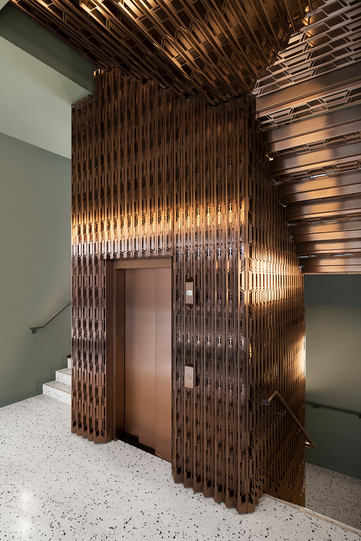 The Gaslight Building, 29 – 35 Rathbone Street, London. - Developer: I.S.A Holdings - Interior architecture and design: bureau de change design office - Architects: dMFK Architects - Laser-cut PVD coloured stainless steel in custom Bronze for stairs, lift core and architectural detailing by Double Stone Steel in partnership with Double Stone Steel Europe Ltd. Showing the lift fascia, doors and stairs rising through the core - Photography by Gilbert McCarragher The Gaslight Building, 29 – 35 Rathbone Street, London. - Developer: I.S.A Holdings - Interior architecture and design: bureau de change design office - Architects: dMFK Architects - Laser-cut PVD coloured stainless steel in custom Bronze for stairs, lift core and architectural detailing by Double Stone Steel in partnership with Double Stone Steel Europe Ltd. Showing the lift fascia, doors and stairs rising through the core - Photography by Gilbert McCarragher