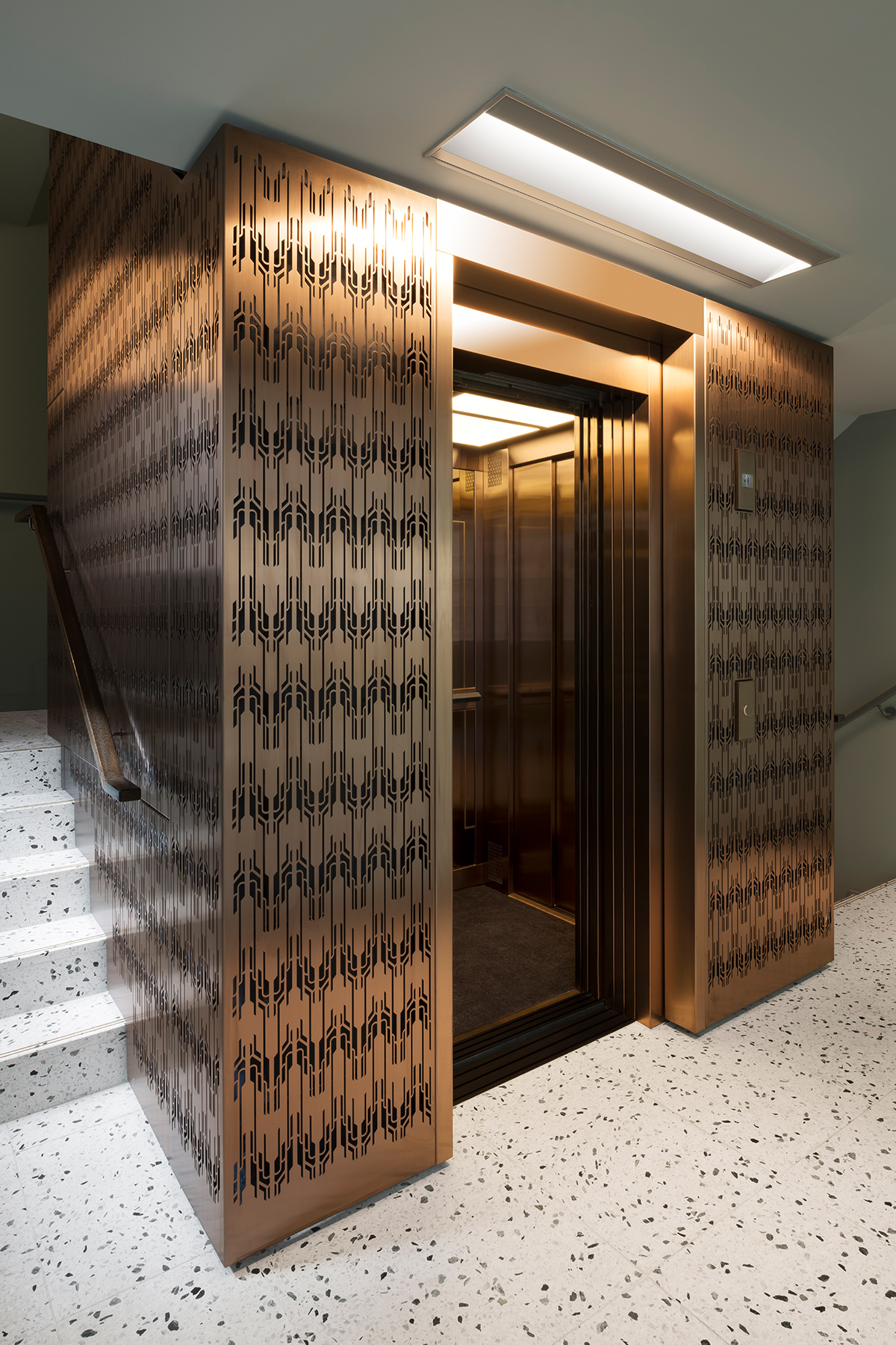 The Gaslight Building, 29 – 35 Rathbone Street, London. - Developer: I.S.A Holdings - Interior architecture and design: bureau de change design office - Architects: dMFK Architects - Laser-cut PVD coloured stainless steel in custom Bronze for stairs, lift core and architectural detailing by Double Stone Steel in partnership with Double Stone Steel Europe Ltd. - Showing the lift core cladding designed to echo the detail and craftsmanship of the Art Deco era - Photography by Gilbert McCarragher The Gaslight Building, 29 – 35 Rathbone Street, London. - Developer: I.S.A Holdings - Interior architecture and design: bureau de change design office - Architects: dMFK Architects - Laser-cut PVD coloured stainless steel in custom Bronze for stairs, lift core and architectural detailing by Double Stone Steel in partnership with Double Stone Steel Europe Ltd. - Showing the lift core cladding designed to echo the detail and craftsmanship of the Art Deco era - Photography by Gilbert McCarragher