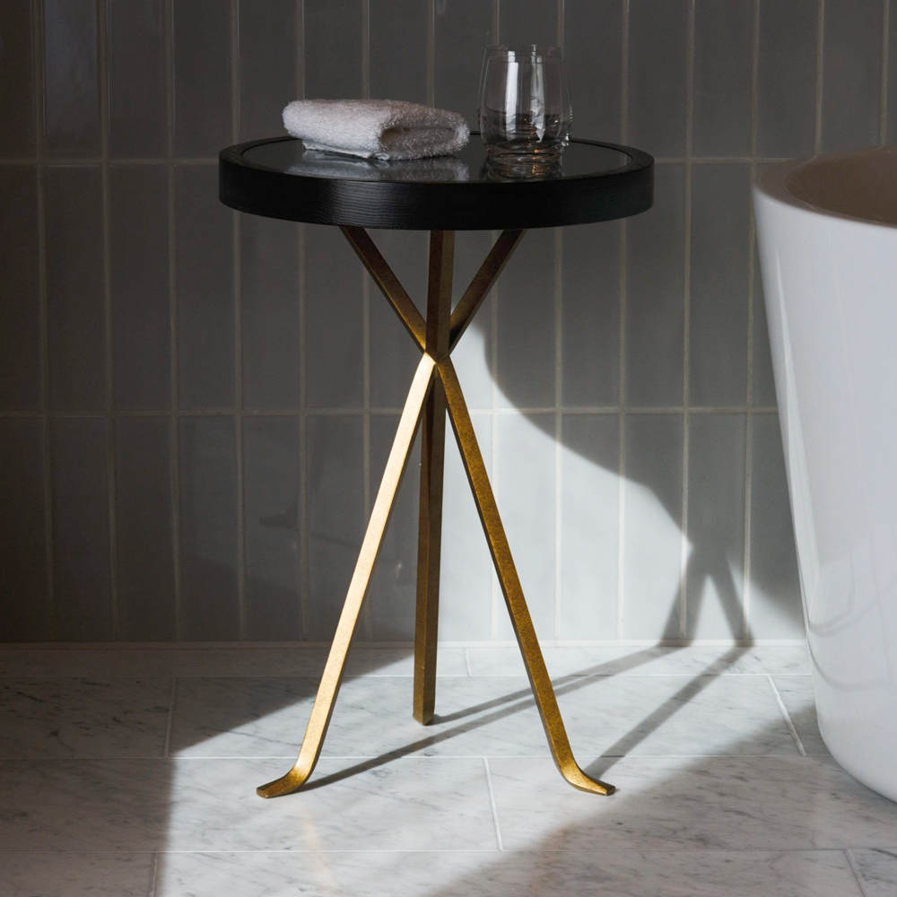 A bespoke side table with legs in flattened bar material for a hotel bathroom, base in PVD coloured stainless steel in Brass by Double Stone Steel Europe Ltd.