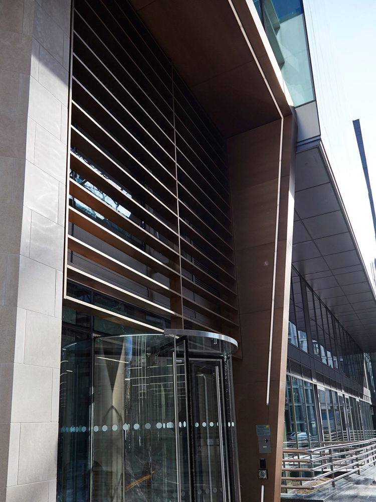 Brise soleil, canopy and column exterior metalwork. - 15 Fetter Lane, EC4A, London. - Architects: McBains - Bronze PVD coloured textured stainless steel Brise soleil, canopy and column in Chocolate. - Architectural Metalwork and PVD by Double Stone Steel Europe Ltd. Brise soleil, canopy and column exterior metalwork. - 15 Fetter Lane, EC4A, London. - Architects: McBains - Bronze PVD coloured textured stainless steel Brise soleil, canopy and column in Chocolate. - Architectural Metalwork and PVD by Double Stone Steel Europe Ltd.