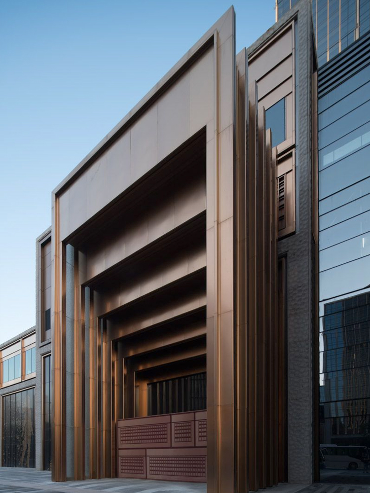 Stepped door entry at the Shanghai Bund Financial Centre in PVD coloured stainless steel, Rose Gold Vibration. - Architects: Foster & Partners; Heatherwick Studio - PVD coloured stainless steel:: Double Stone Steel in partnership with Double Stone Steel Europe Ltd. Stepped door entry at the Shanghai Bund Financial Centre in PVD coloured stainless steel, Rose Gold Vibration. - Architects: Foster & Partners; Heatherwick Studio - PVD coloured stainless steel:: Double Stone Steel in partnership with Double Stone Steel Europe Ltd.