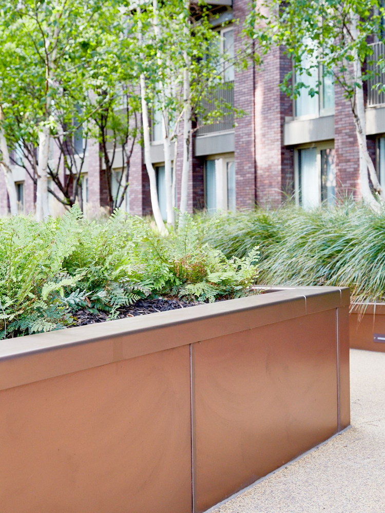Integrated planters in Bronze sandblasted PVD coloured stainless steel. - Embassy Gardens, Nine Elms, Wandsworth, London, UK. - Landscape Architect: Camlins; Hyland Edgar Driver - Bespoke design and fabrication: Double Stone Steel Europe Ltd working with In-Ex Landscapes. Integrated planters in Bronze sandblasted PVD coloured stainless steel. - Embassy Gardens, Nine Elms, Wandsworth, London, UK. - Landscape Architect: Camlins; Hyland Edgar Driver - Bespoke design and fabrication: Double Stone Steel Europe Ltd working with In-Ex Landscapes.